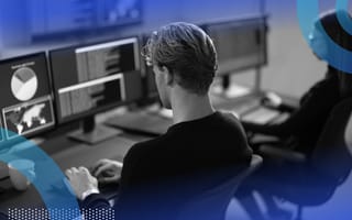 Two cybersecurity professionals work on terminals
